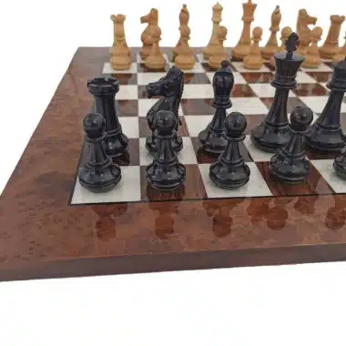 Piezas negras en primer plano sobre el tablero de raíz de nogal, vista cercana