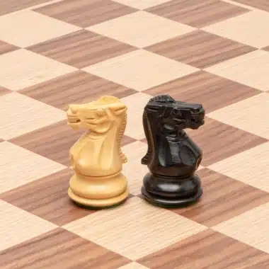 Caballos Highclere claro y oscuro colocados sobre el tablero de arce y nogal